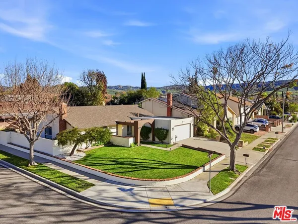 an aerial view of a house with a garden and trees