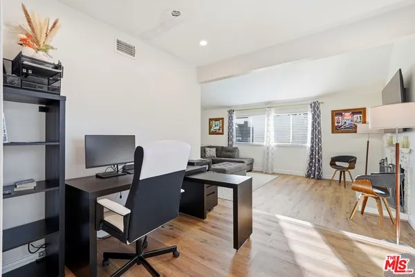 a view of a workspace with furniture and a workspace