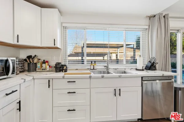 a kitchen with appliances cabinets and a sink