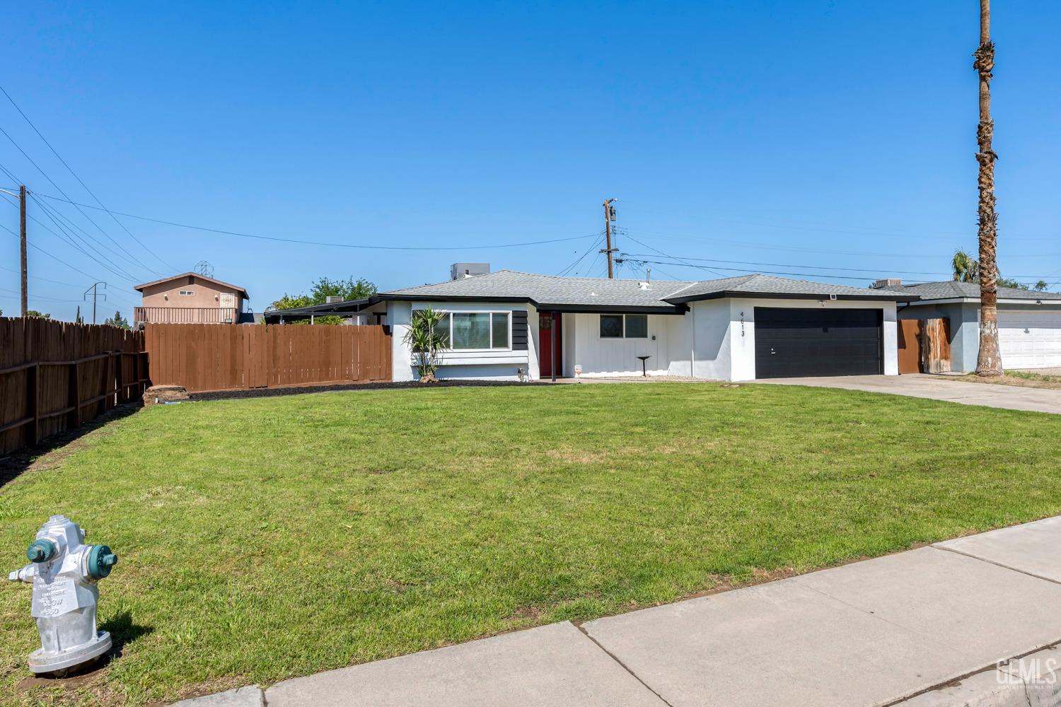 Undisclosed Address Bakersfield, CA 93307 - Photo 1 of 46 a front view of a house with garden