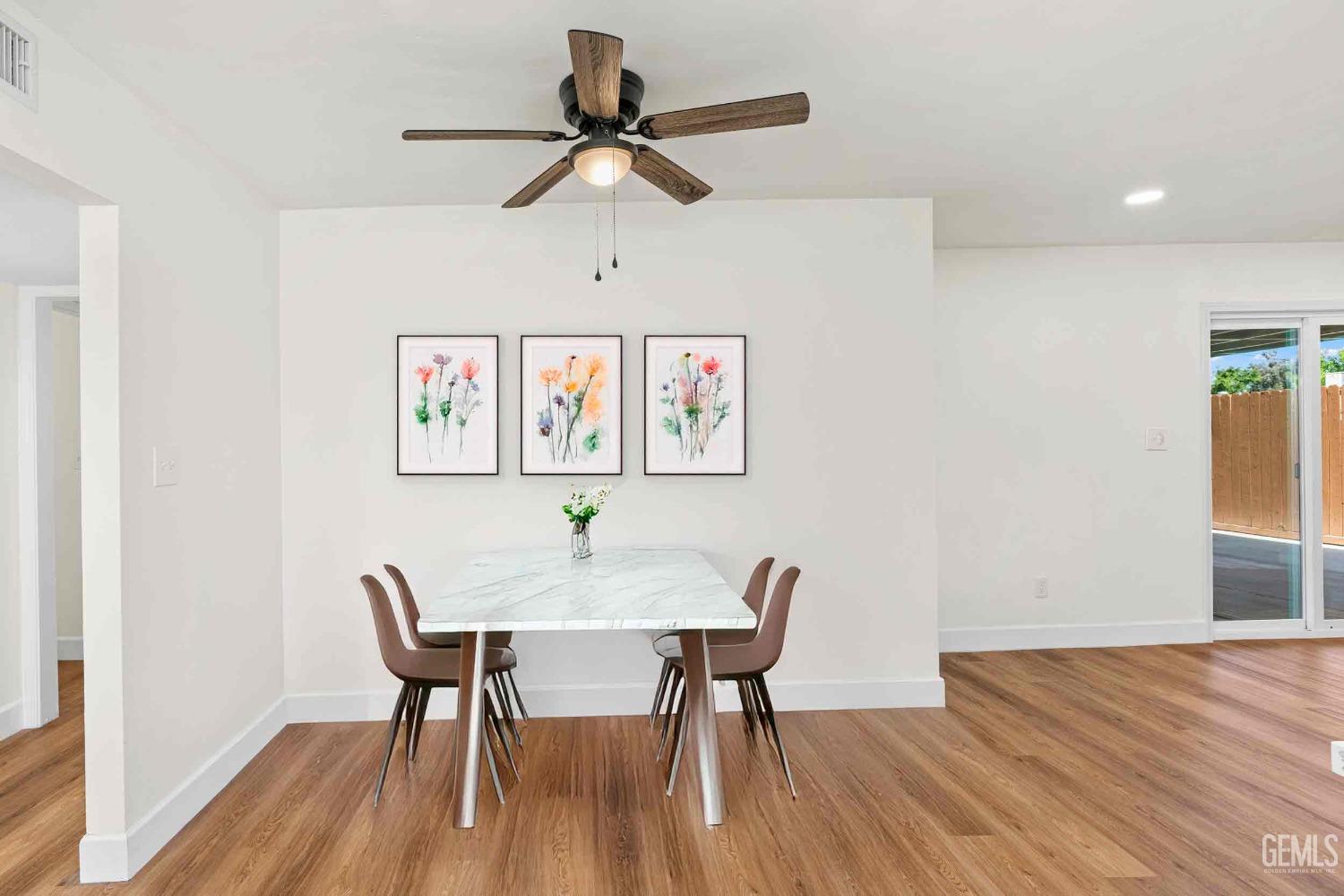 Undisclosed Address Bakersfield, CA 93307 - Photo 12 of 46 a view of a dining room with furniture and wooden floor