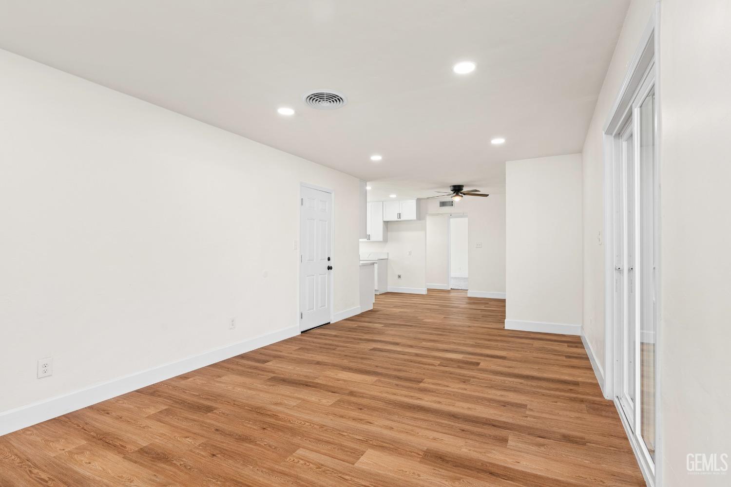 Undisclosed Address Bakersfield, CA 93307 - Photo 16 of 46 a view of an empty room with wooden floor
