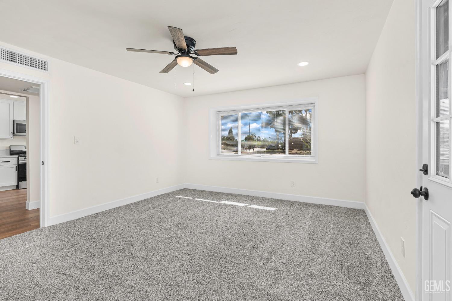 Undisclosed Address Bakersfield, CA 93307 - Photo 18 of 46 a view of an empty room with a window