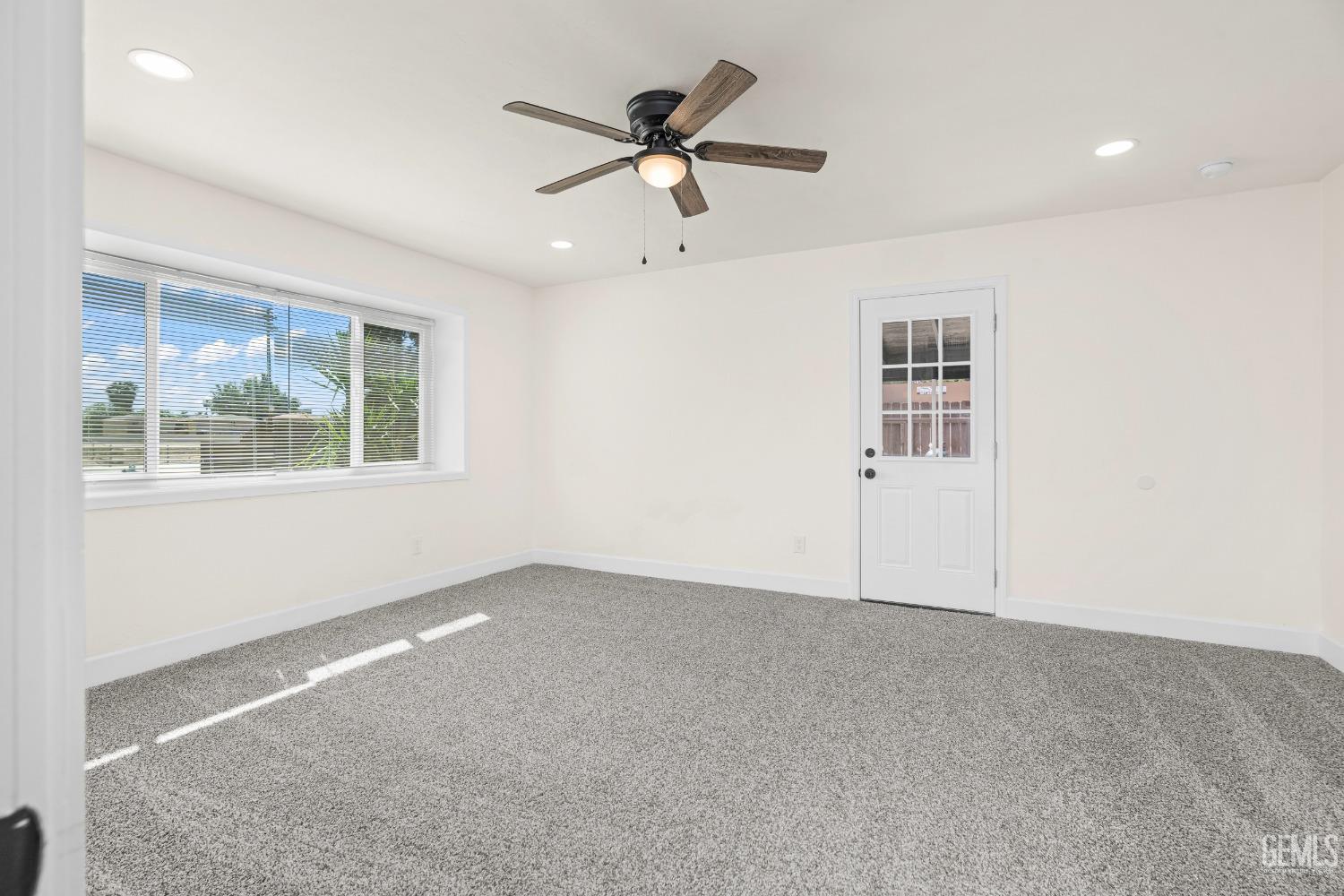 Undisclosed Address Bakersfield, CA 93307 - Photo 19 of 46 an empty room with window and ceiling fan