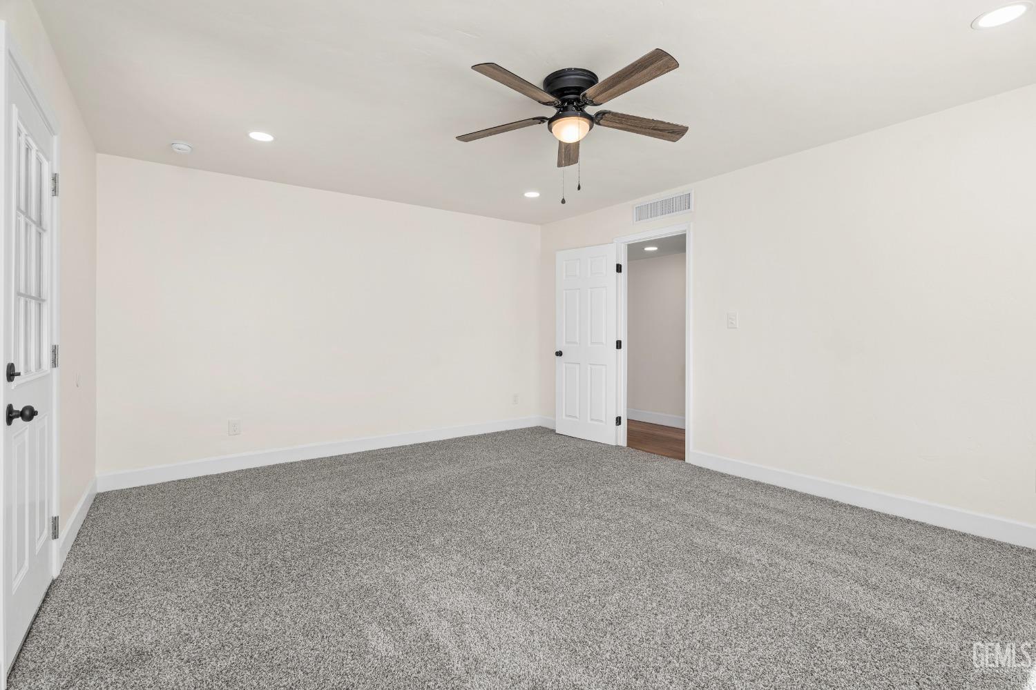 Undisclosed Address Bakersfield, CA 93307 - Photo 20 of 46 an empty room with a ceiling fan and a window