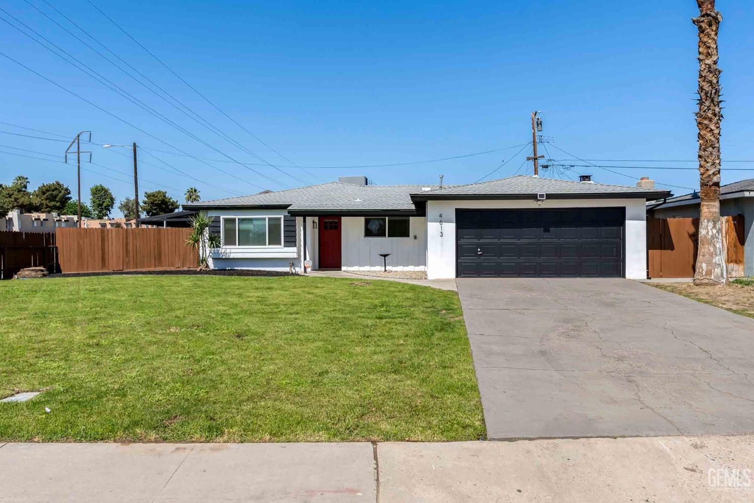 Undisclosed Address Bakersfield, CA 93307 - Photo 2 of 46 a front view of a house with garden