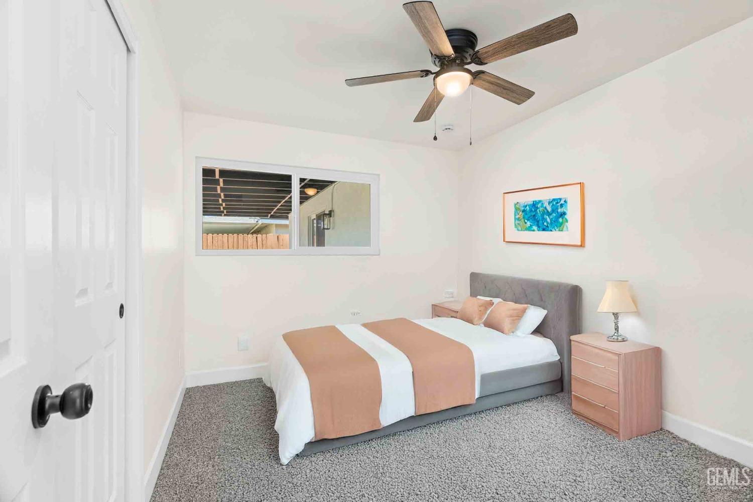 Undisclosed Address Bakersfield, CA 93307 - Photo 22 of 46 a bedroom with a bed and a ceiling fan