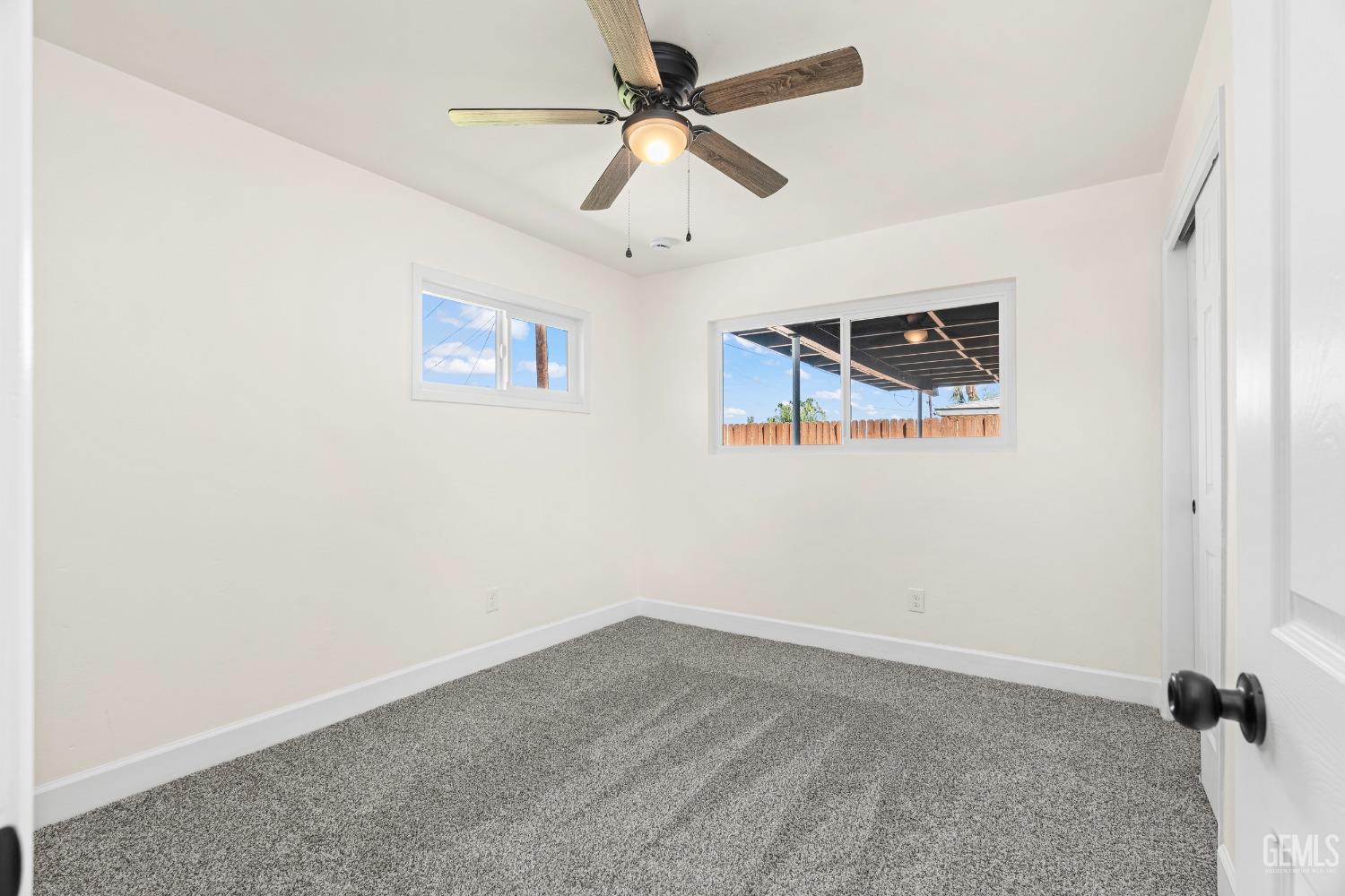 Undisclosed Address Bakersfield, CA 93307 - Photo 26 of 46 an empty room with ceiling fan and window