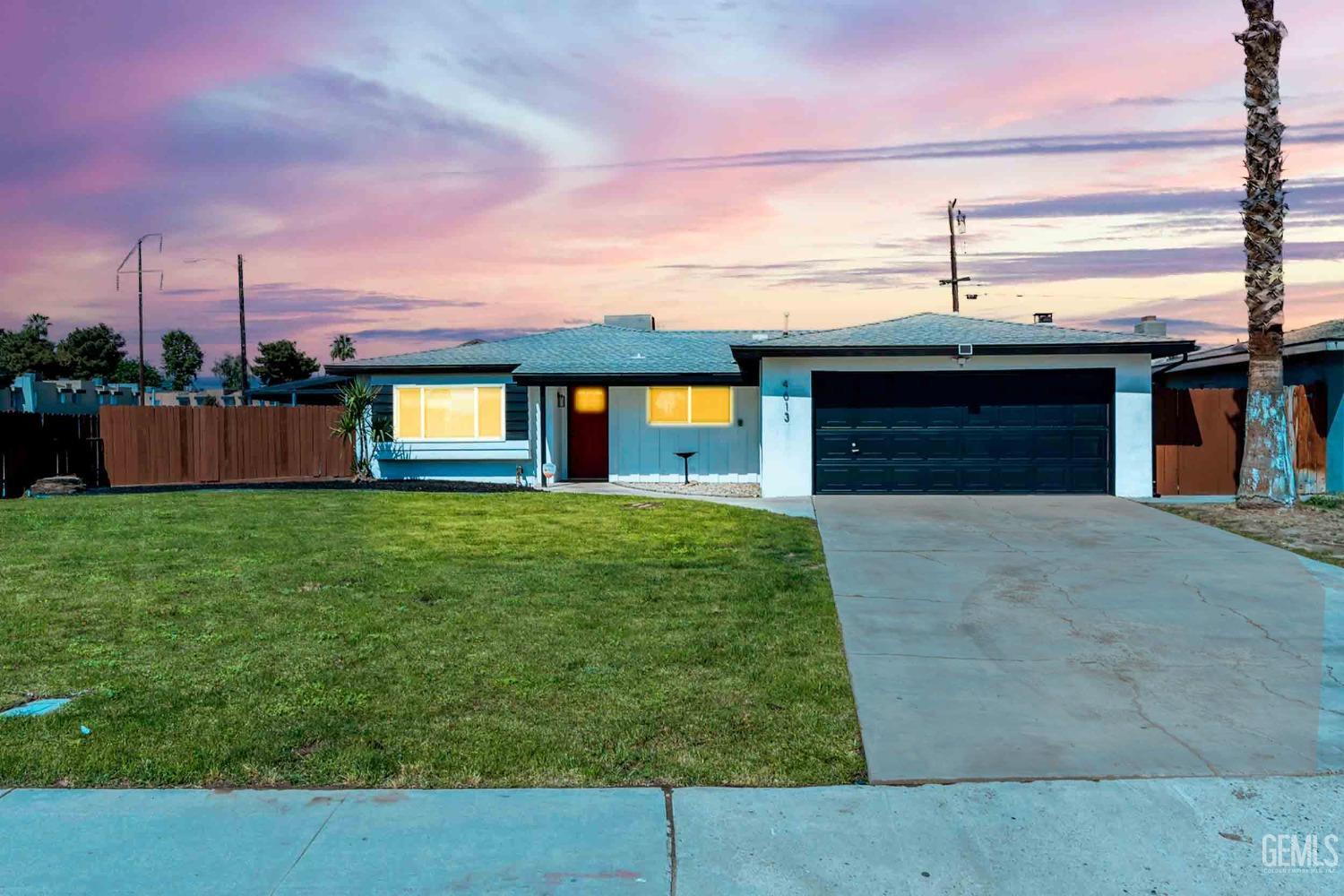 Undisclosed Address Bakersfield, CA 93307 - Photo 3 of 46 a front view of a house with a garden and yard