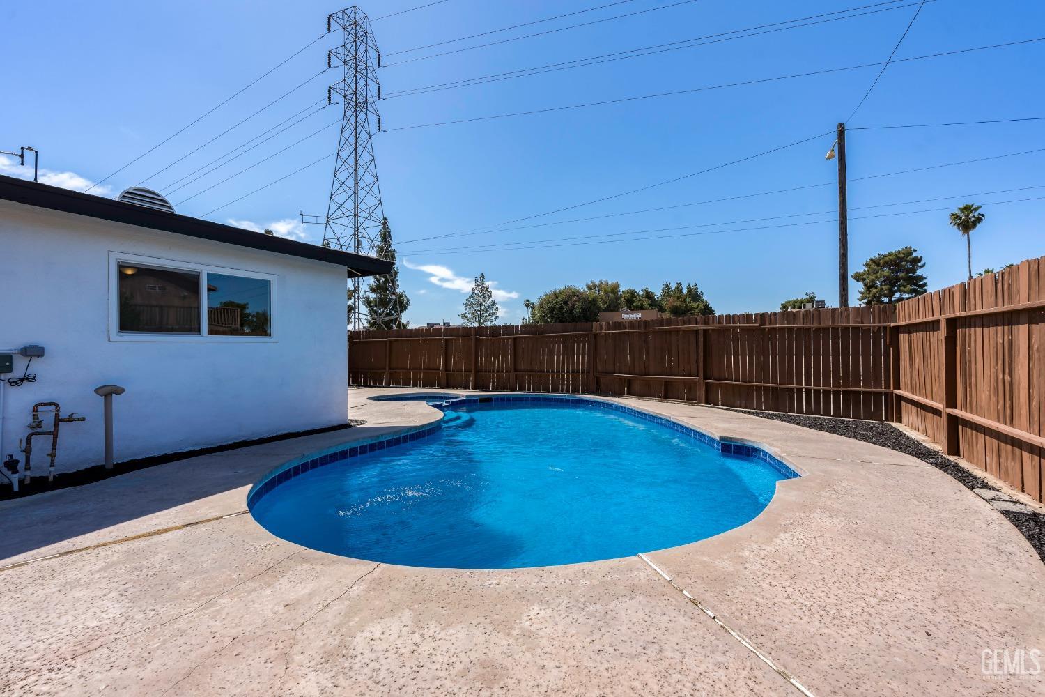 Undisclosed Address Bakersfield, CA 93307 - Photo 39 of 46 a view of a backyard with a swimming pool