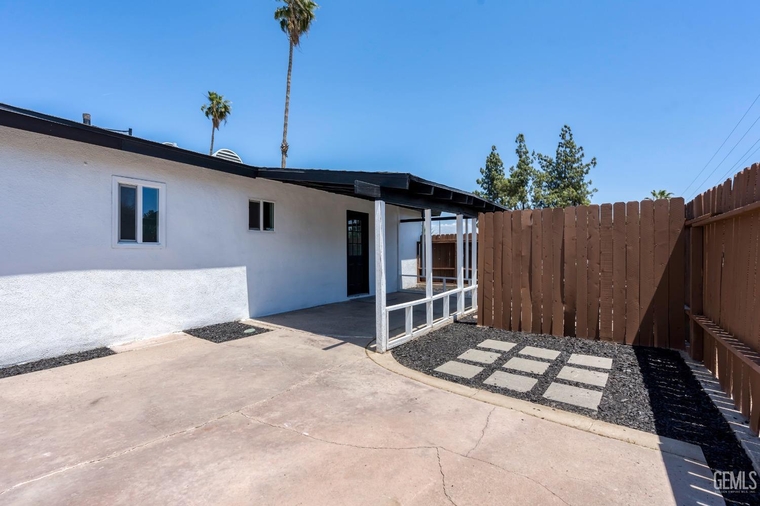 Undisclosed Address Bakersfield, CA 93307 - Photo 42 of 46 a front view of a house with a garden