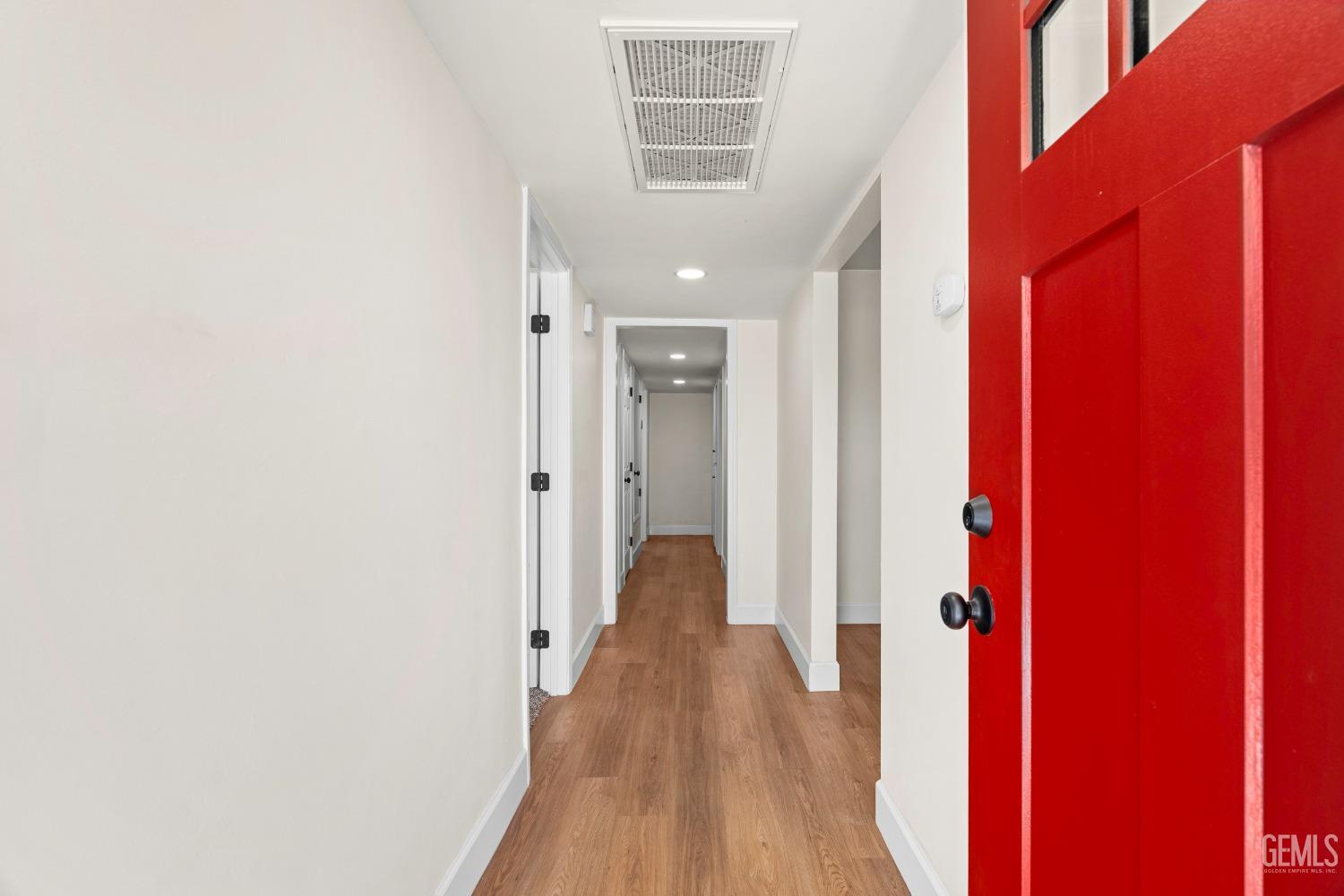 Undisclosed Address Bakersfield, CA 93307 - Photo 7 of 46 a view of a hallway with wooden floor and staircase