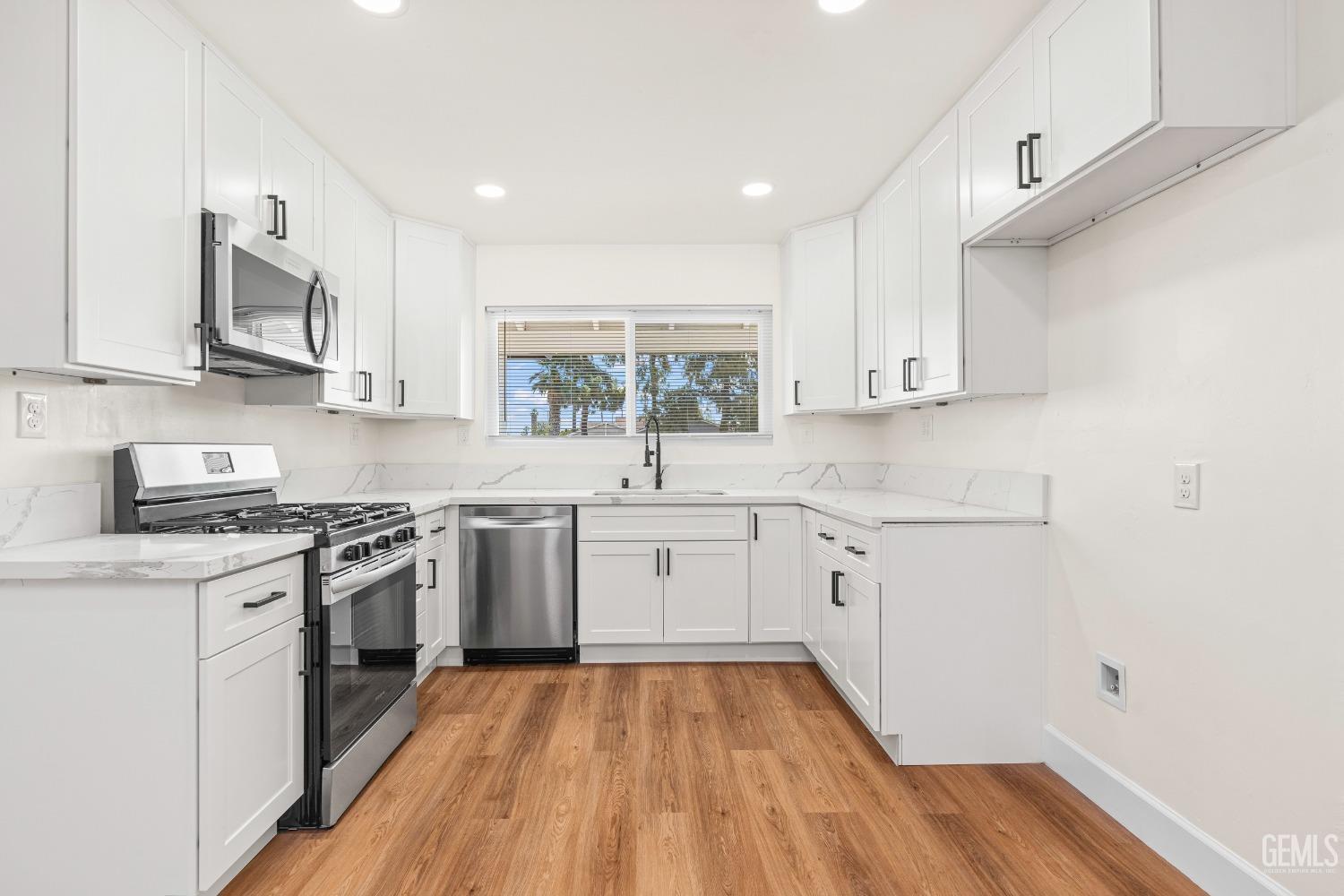 Undisclosed Address Bakersfield, CA 93307 - Photo 9 of 46 a kitchen with stainless steel appliances a white stove top oven sink and cabinets