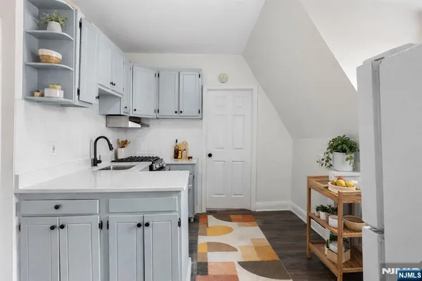 a view of kitchen with sink and cabinets