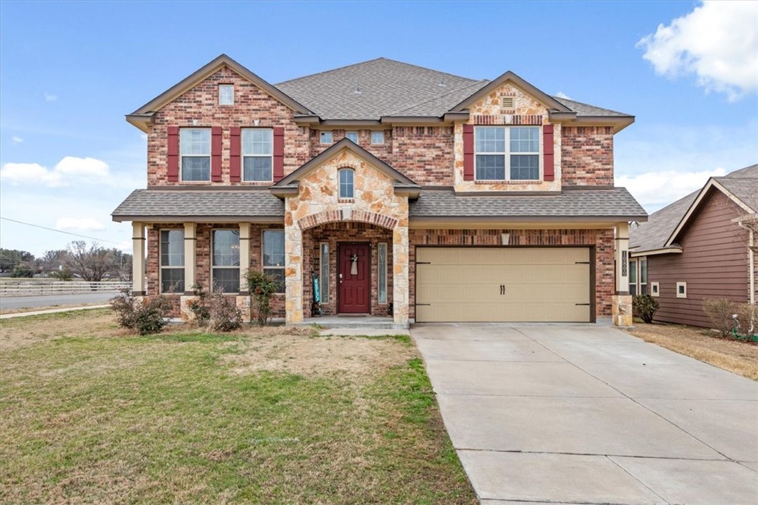a front view of a house with a yard and garage
