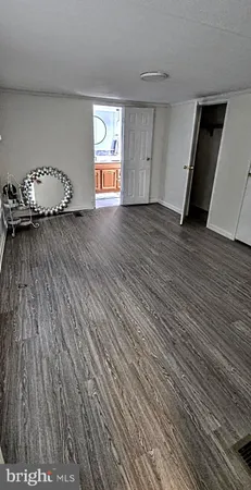 a view of a livingroom with wooden floor and closet