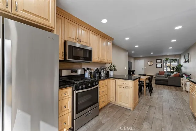 a kitchen with a sink stainless steel appliances and cabinets