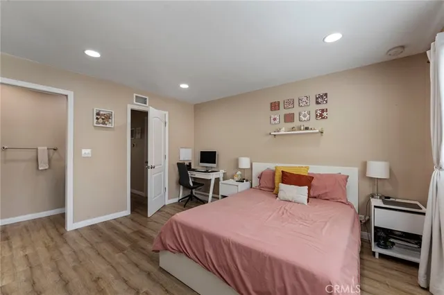 a bedroom with a bed and a television