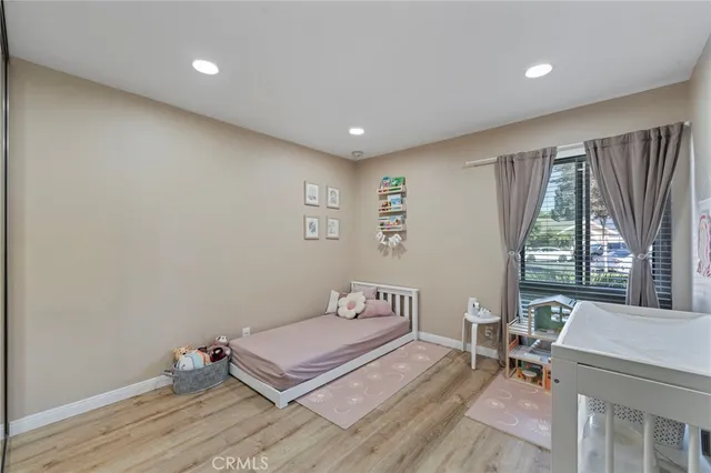 a spacious bedroom with a bed and large windows