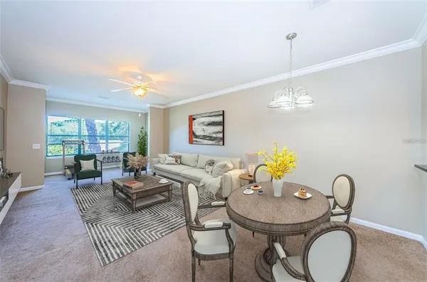 a living room with furniture a chandelier and a dining table