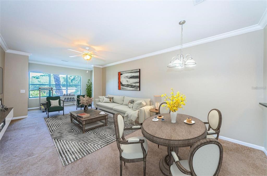 2254 Chianti Place, Unit 66 Palm Harbor, FL 34683 - Photo 2 of 20 a living room with furniture a chandelier and a dining table