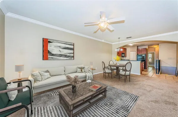 a living room with furniture a rug and a chandelier