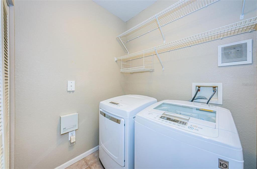 2254 Chianti Place, Unit 66 Palm Harbor, FL 34683 - Photo 4 of 20 a utility room with dryer and washer