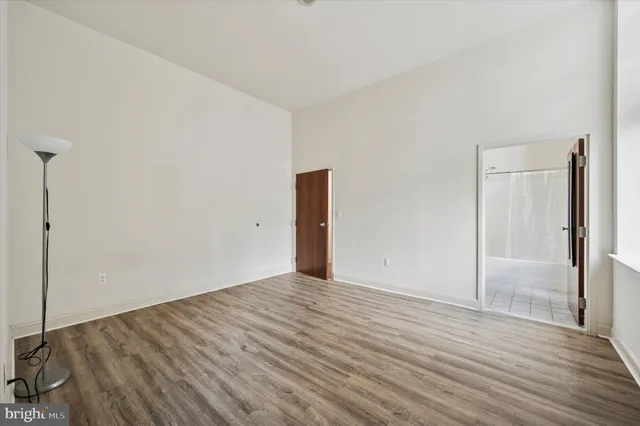 a view of an empty room with wooden floor