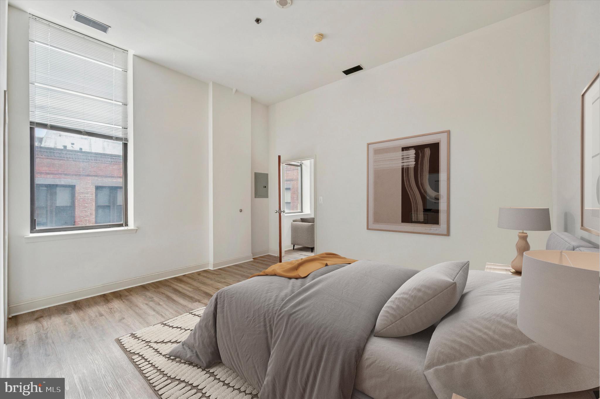 1001 Chestnut Street, Unit 904W Philadelphia, PA 19103 - Photo 16 of 25 a bedroom with a bed and wooden floor