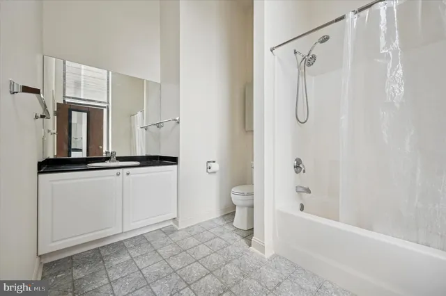 a bathroom with a double vanity sink a mirror and a bathtub