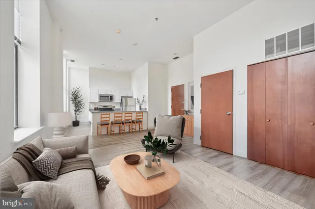 a living room with furniture and kitchen view