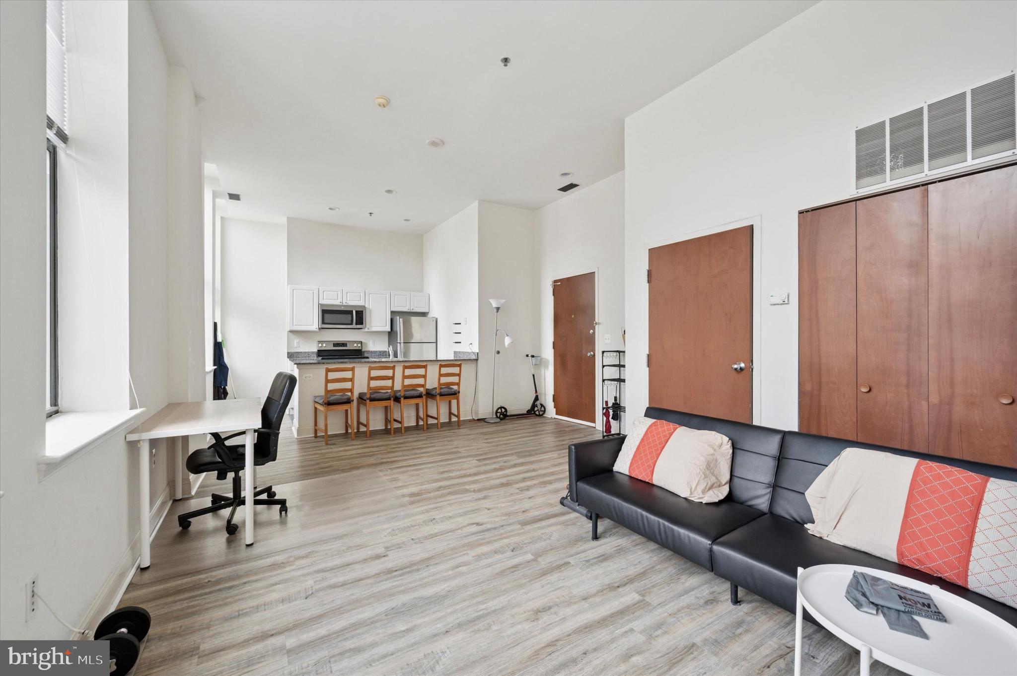 1001 Chestnut Street, Unit 904W Philadelphia, PA 19103 - Photo 5 of 25 a living room with furniture and a table