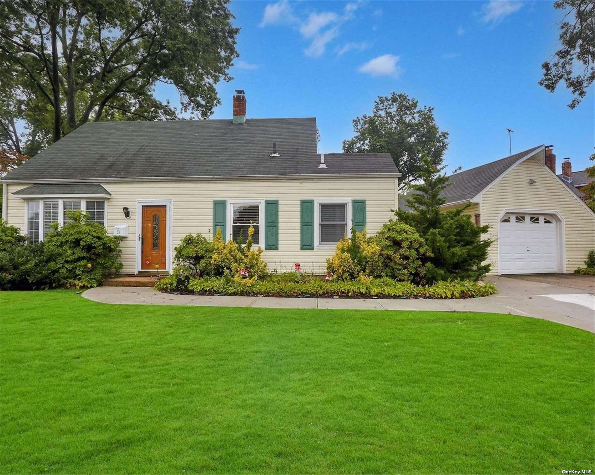 3 Periwinkle Road Levittown, NY 11756 - Photo 1 of 1 a front view of a house with a yard and garage