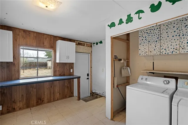 an empty room with closet and windows