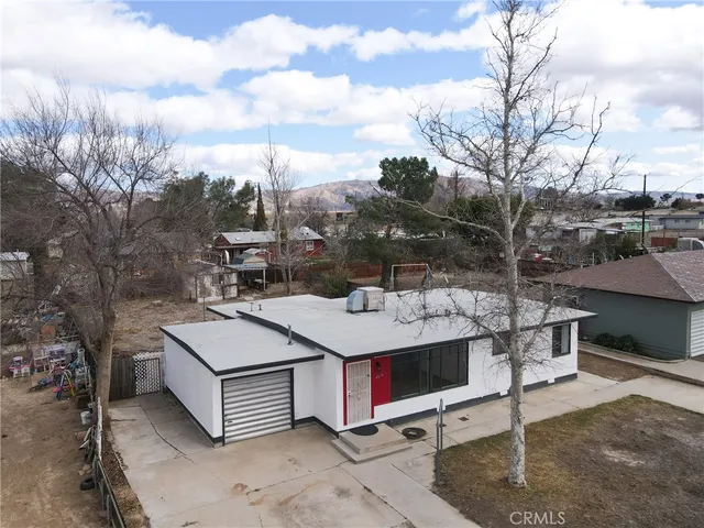 an aerial view of a residential houses with outdoor space