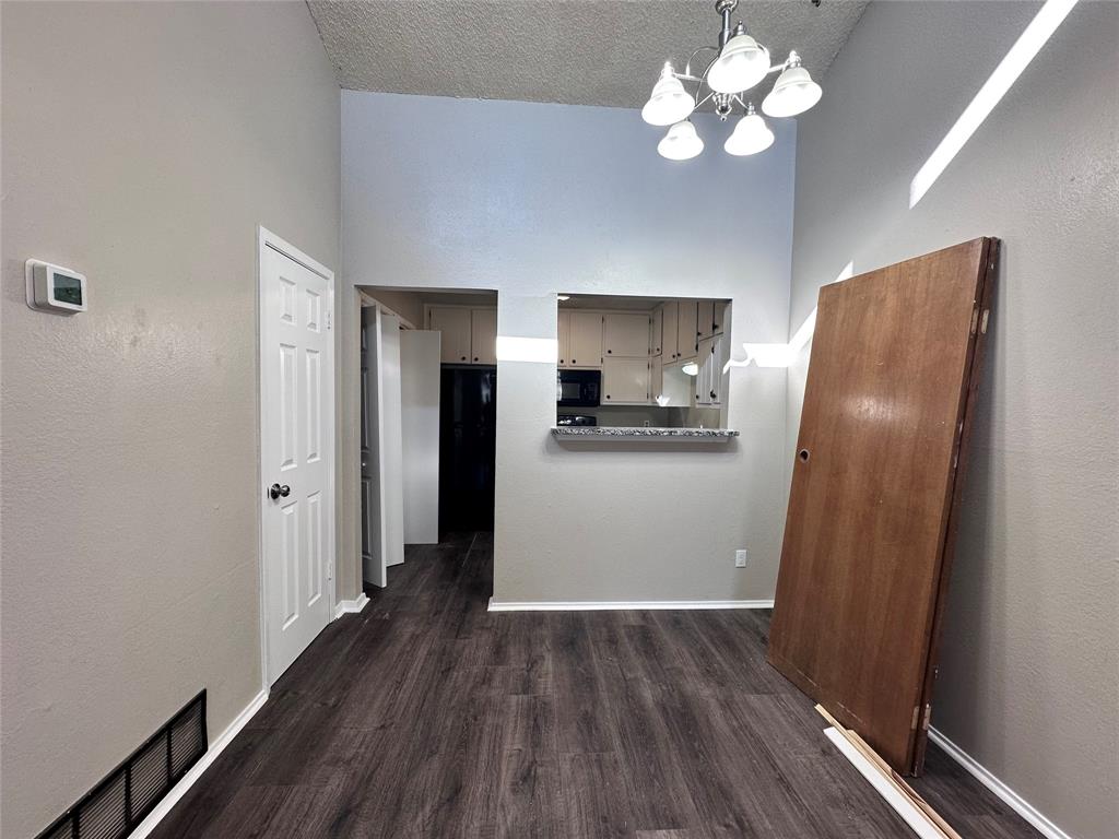 1110 B Lynn Street Weatherford, TX 76086 - Photo 4 of 8 a view of a kitchen with wooden floor and a ceiling fan