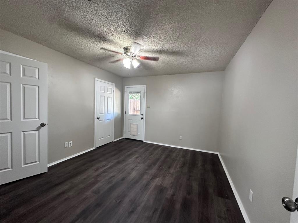 1110 B Lynn Street Weatherford, TX 76086 - Photo 7 of 8 wooden floor in an empty room with a window