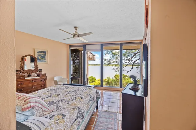 a bedroom with a bed and a large window