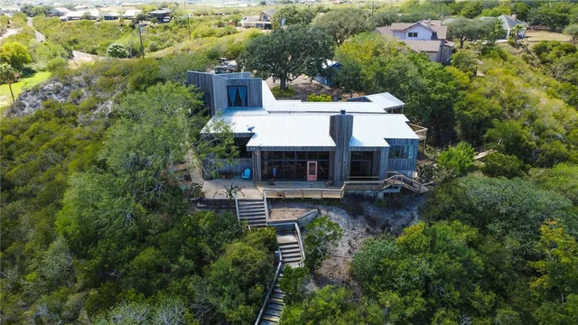 an aerial view of a house with a yard