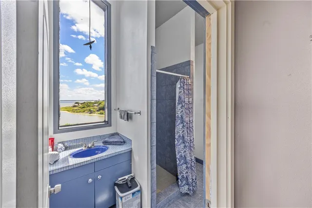 a bathroom with a sink vanity and a mirror