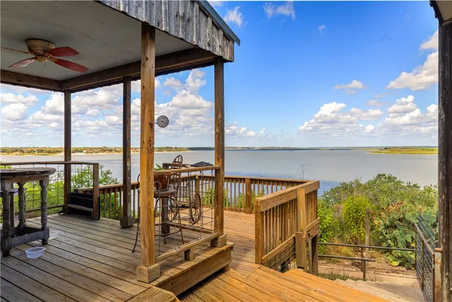 a view of a balcony with wooden floor and outdoor seating