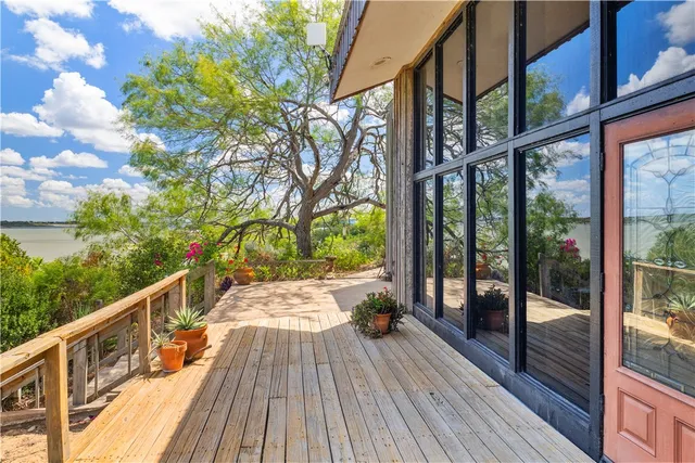 a view of balcony with wooden floor and fence