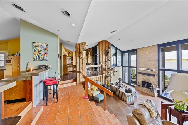 a living room with furniture pool table and a large window