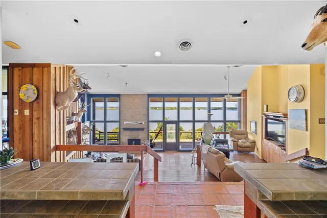 a living room with lots of furniture and a large window