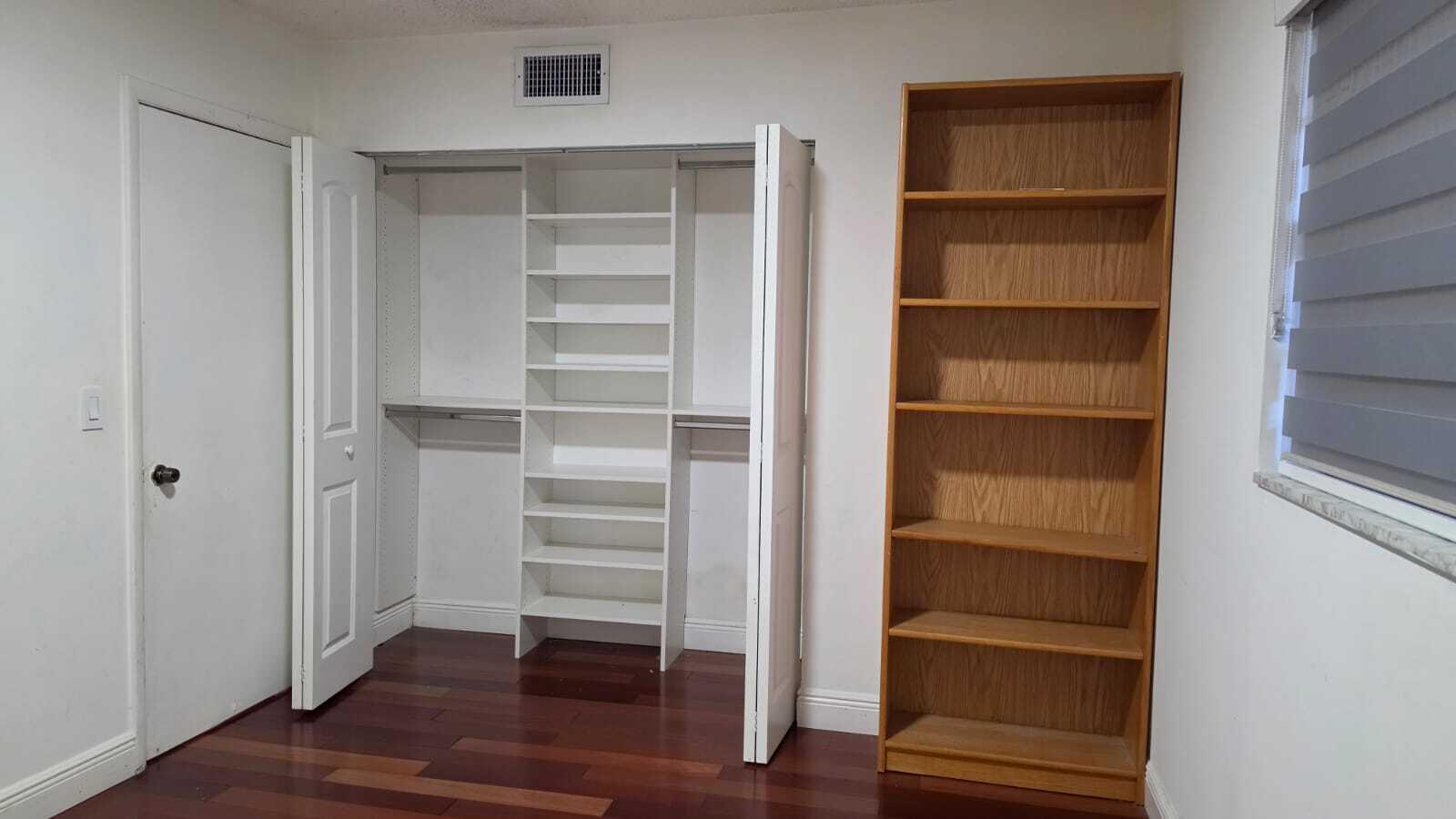 100 Ashbury Road, Unit 206 Hollywood, FL 33024 - Photo 22 of 23 a view of walk in closet with empty racks
