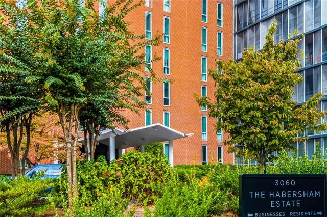 front view of a building with a garden