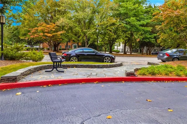 a small garden with trees in the background