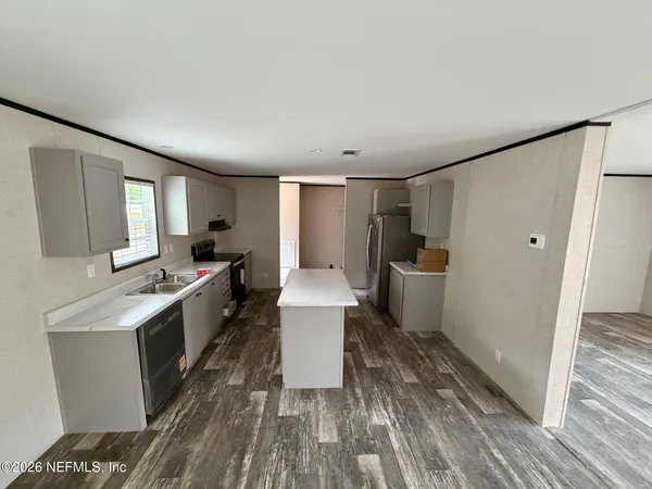 a kitchen with a sink and refrigerator