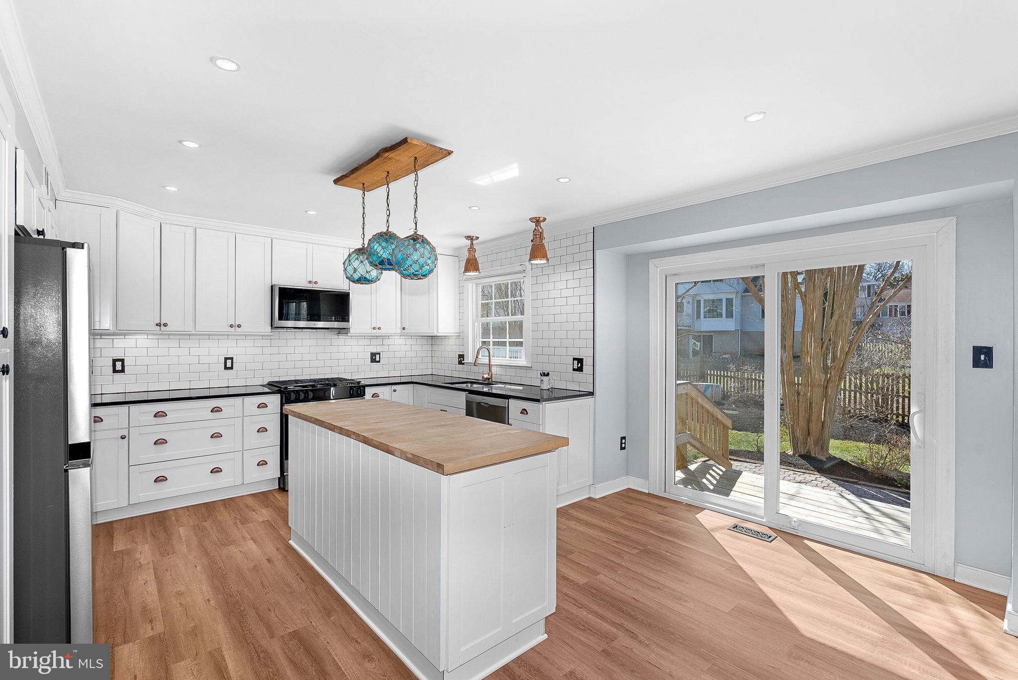 105 Country Road Sterling, VA 20165 - Photo 13 of 49 a kitchen with granite countertop a sink stove and refrigerator