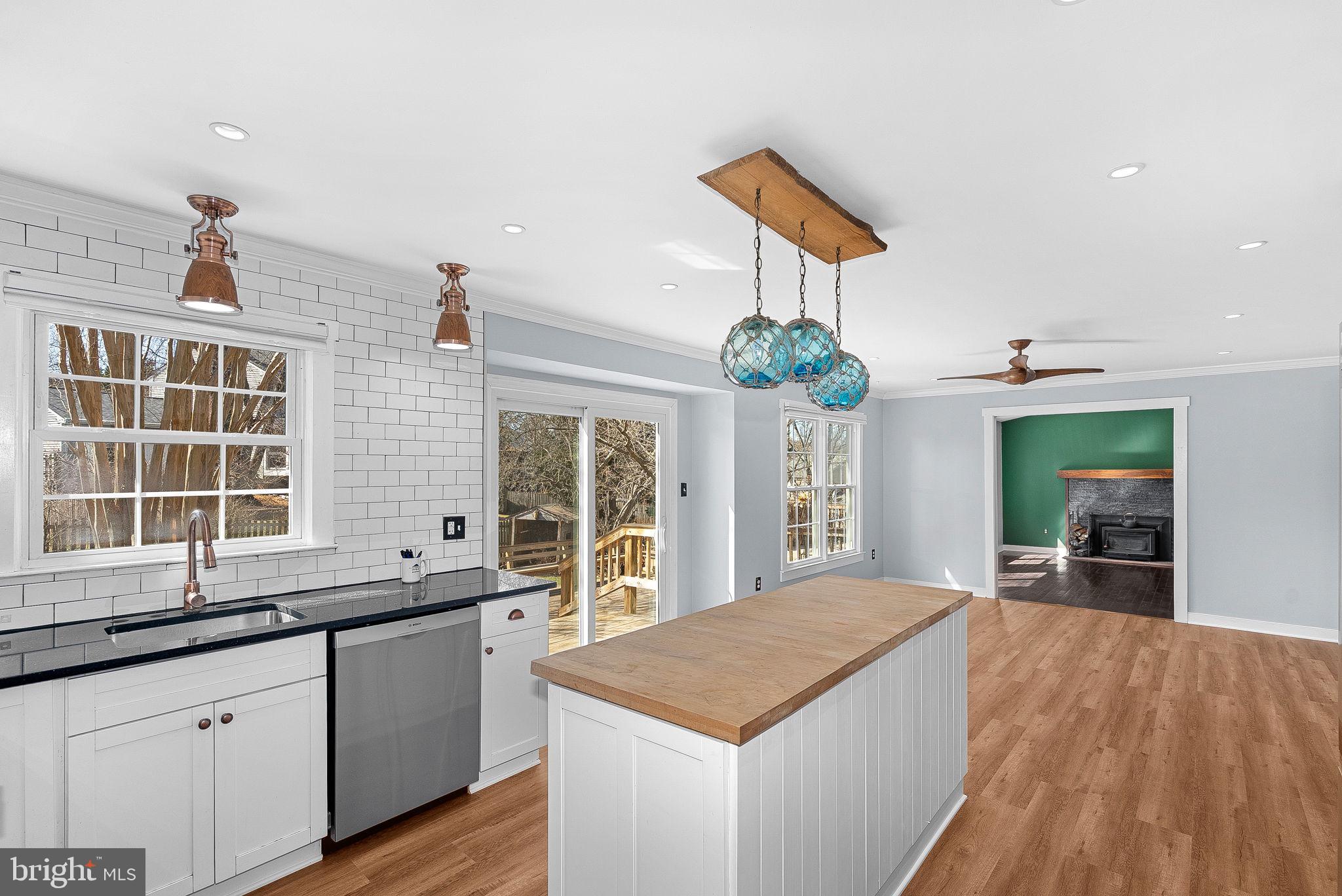 105 Country Road Sterling, VA 20165 - Photo 16 of 49 a kitchen with stainless steel appliances granite countertop a sink and dishwasher a stove with wooden floor